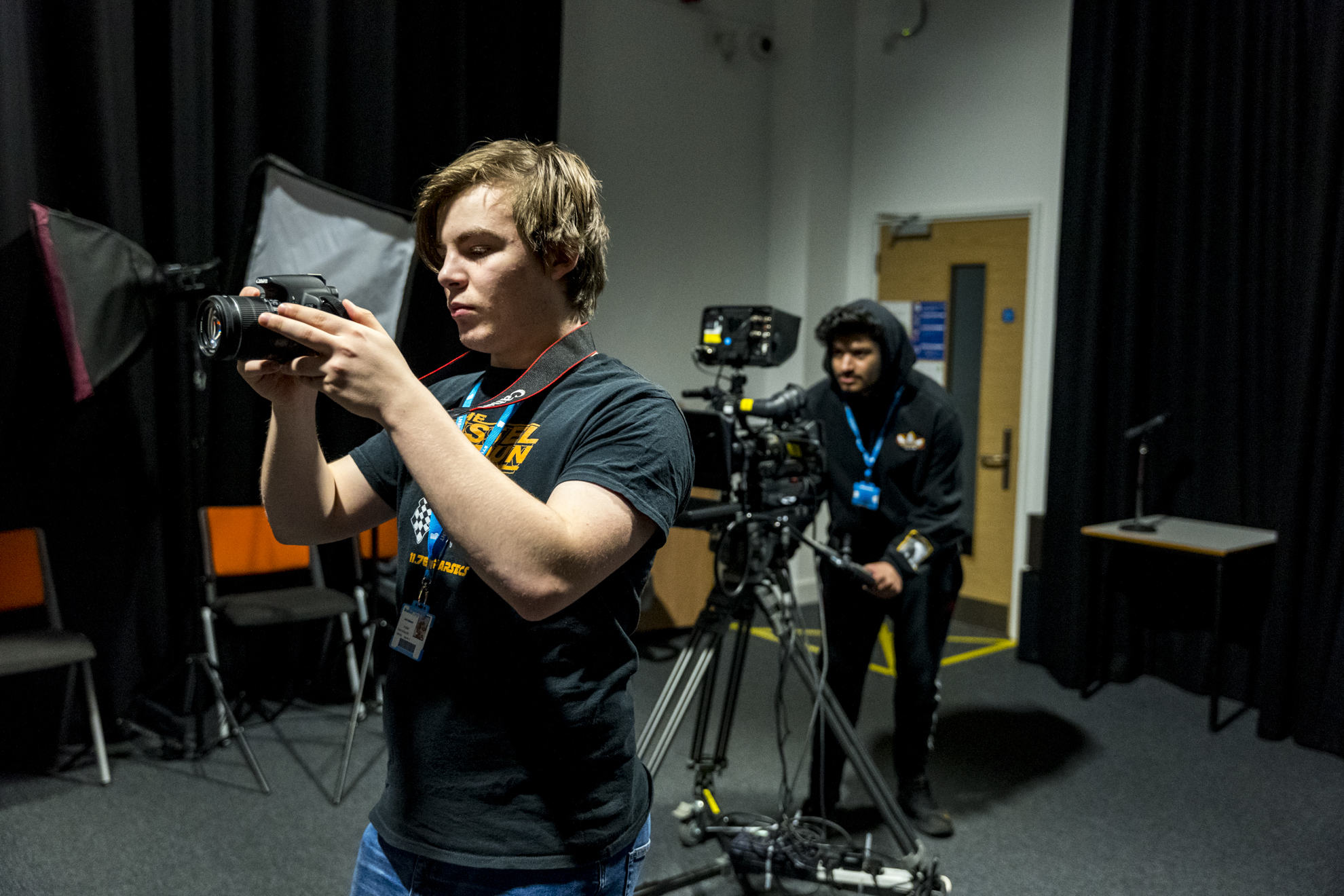 two students using camera equipment in the filming studio
